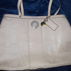 Cream colored coach purse mint condition.